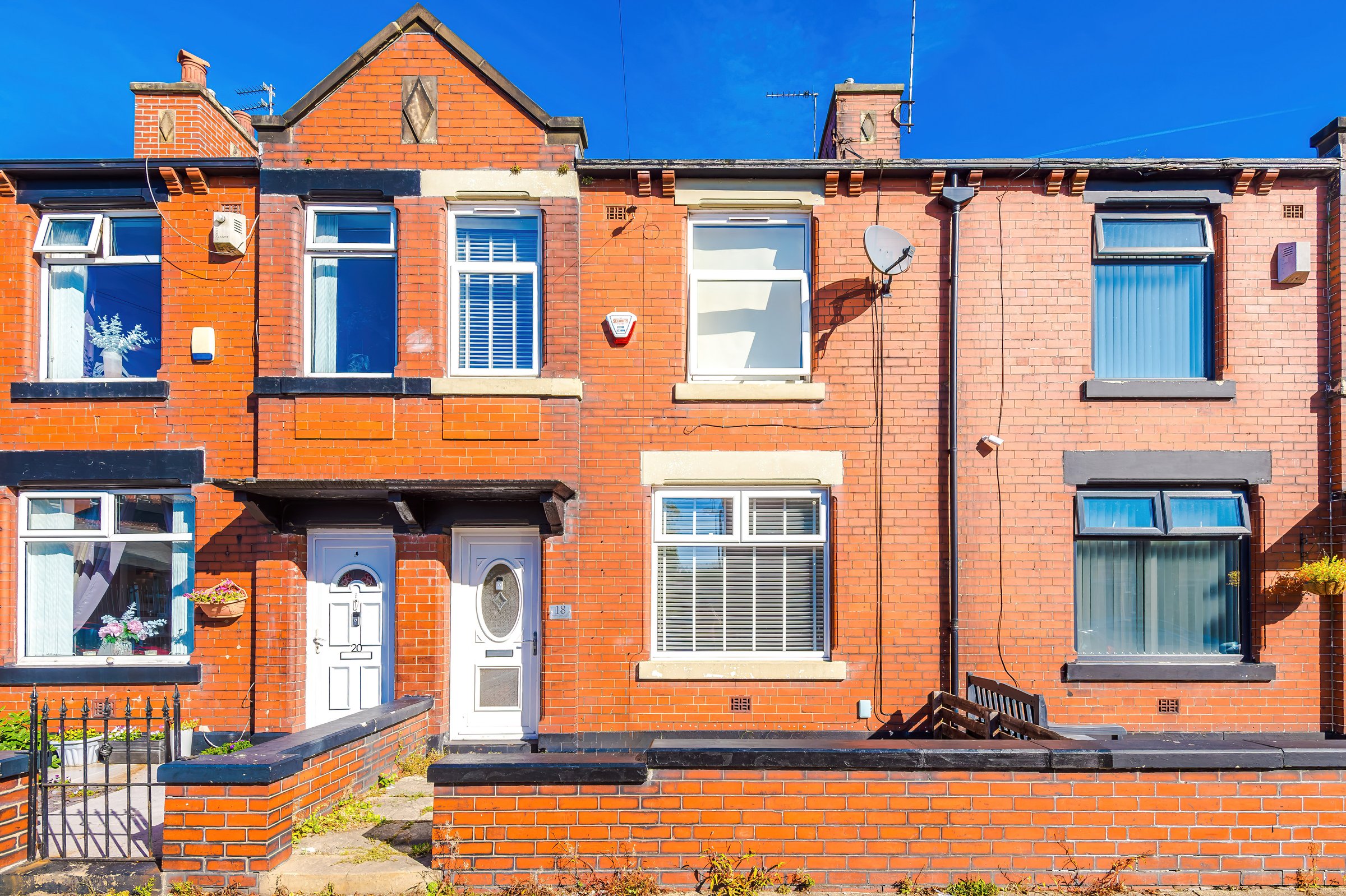 Front of the red brick terraced house on Woodstock Street