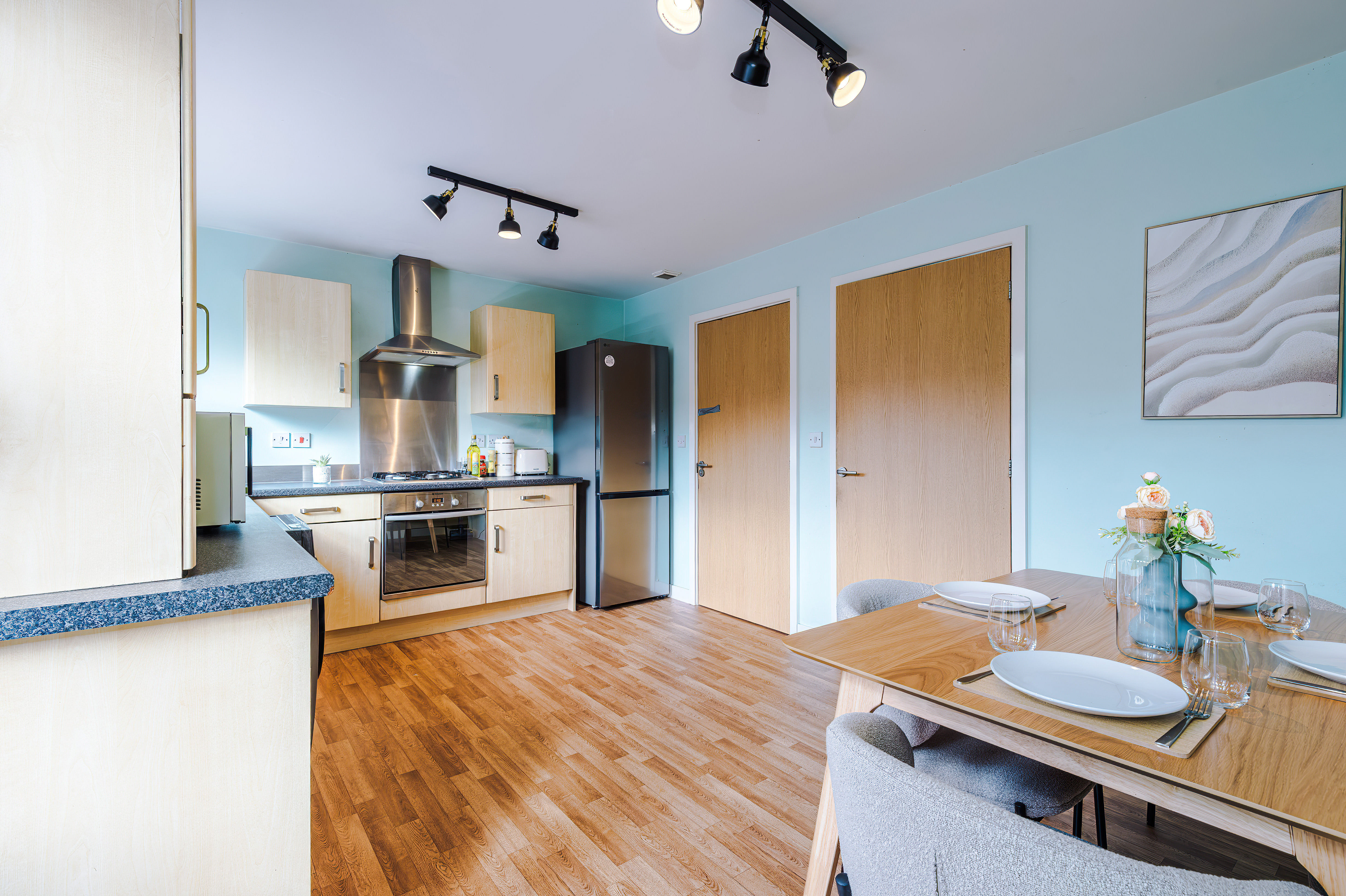 Wider view of the kitchen and dining area