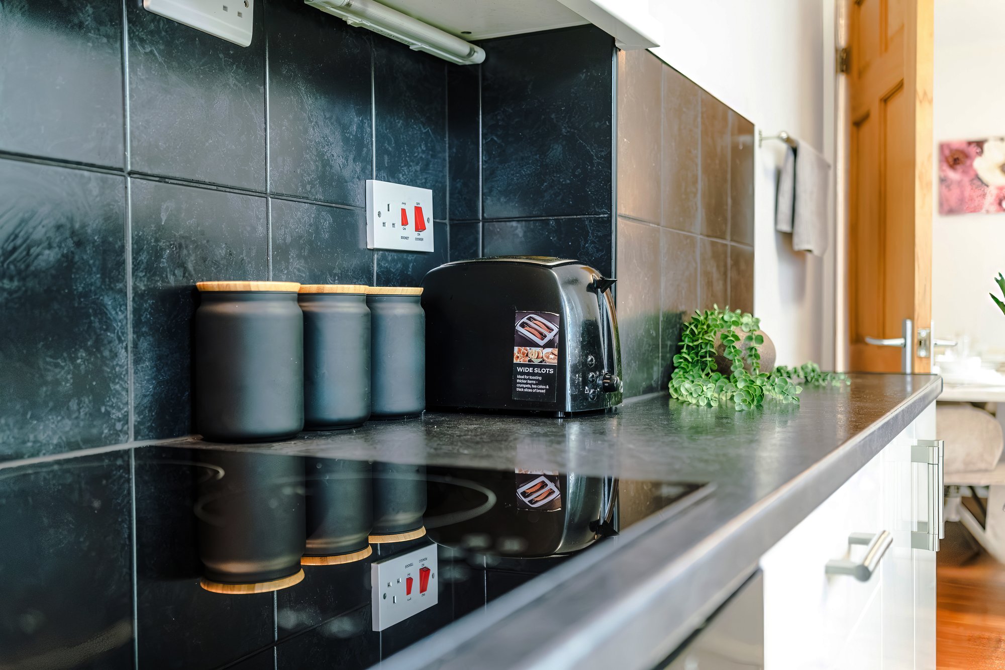 Kitchen worktop with canisters, toaster and hob