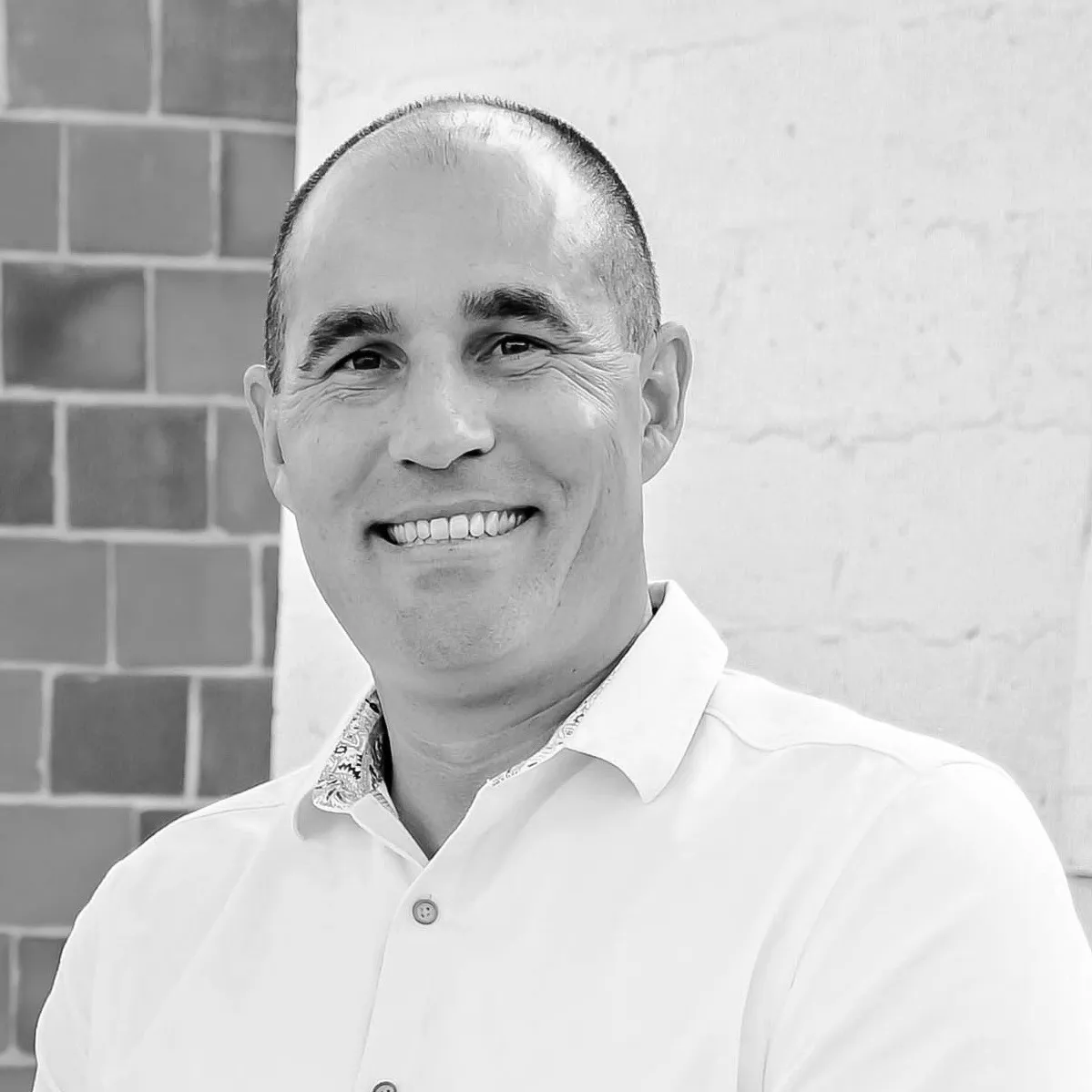 Headshot in black and white of TJ Joyce, COO of Carlock Automotive