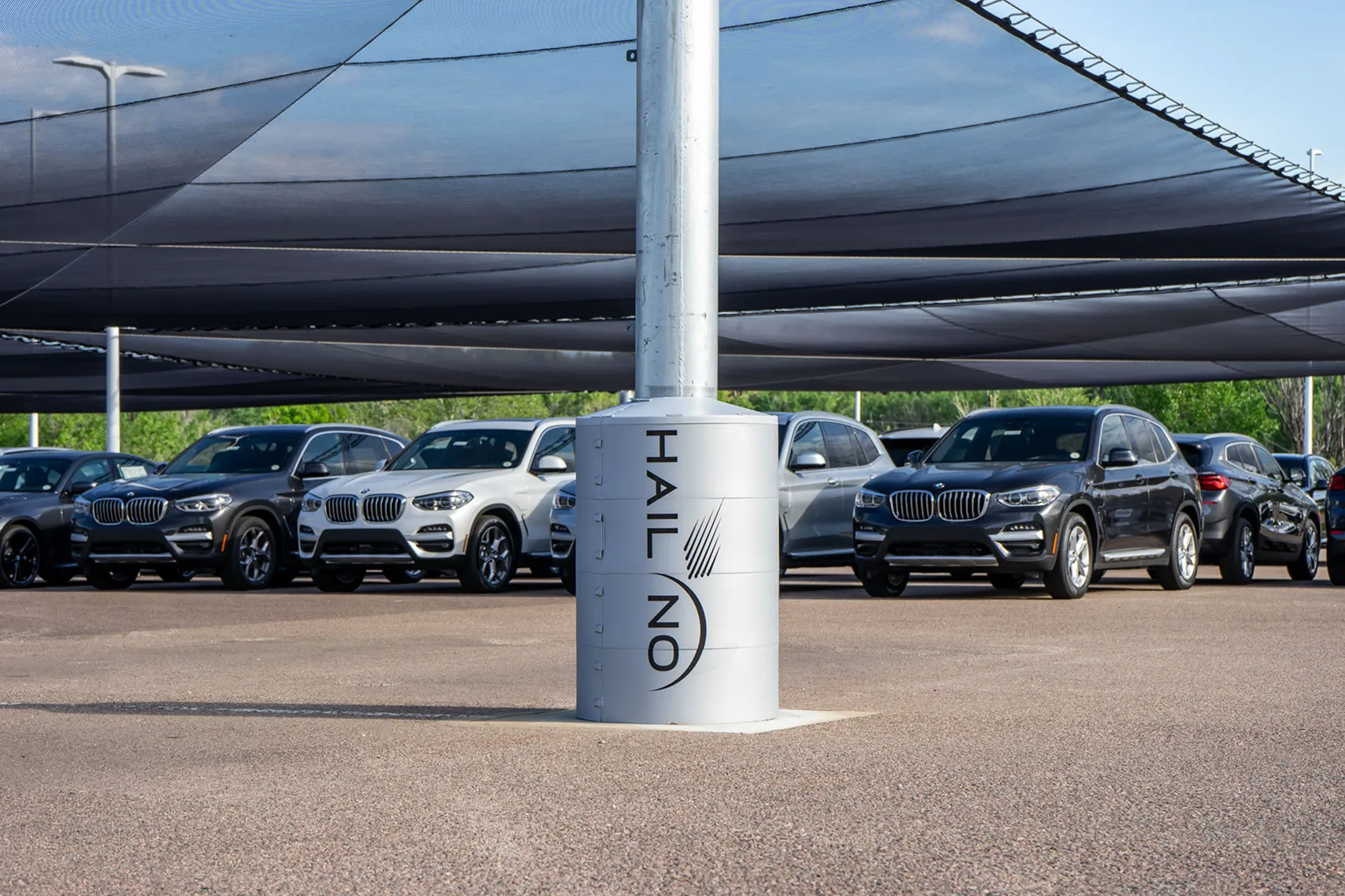 Vehicles protected under a Hail No canopy system