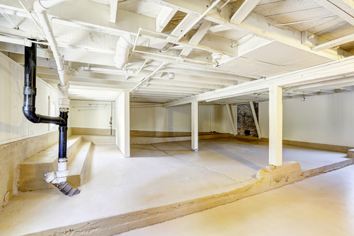 Components of a basement HVAC system, including ducts and vents.
