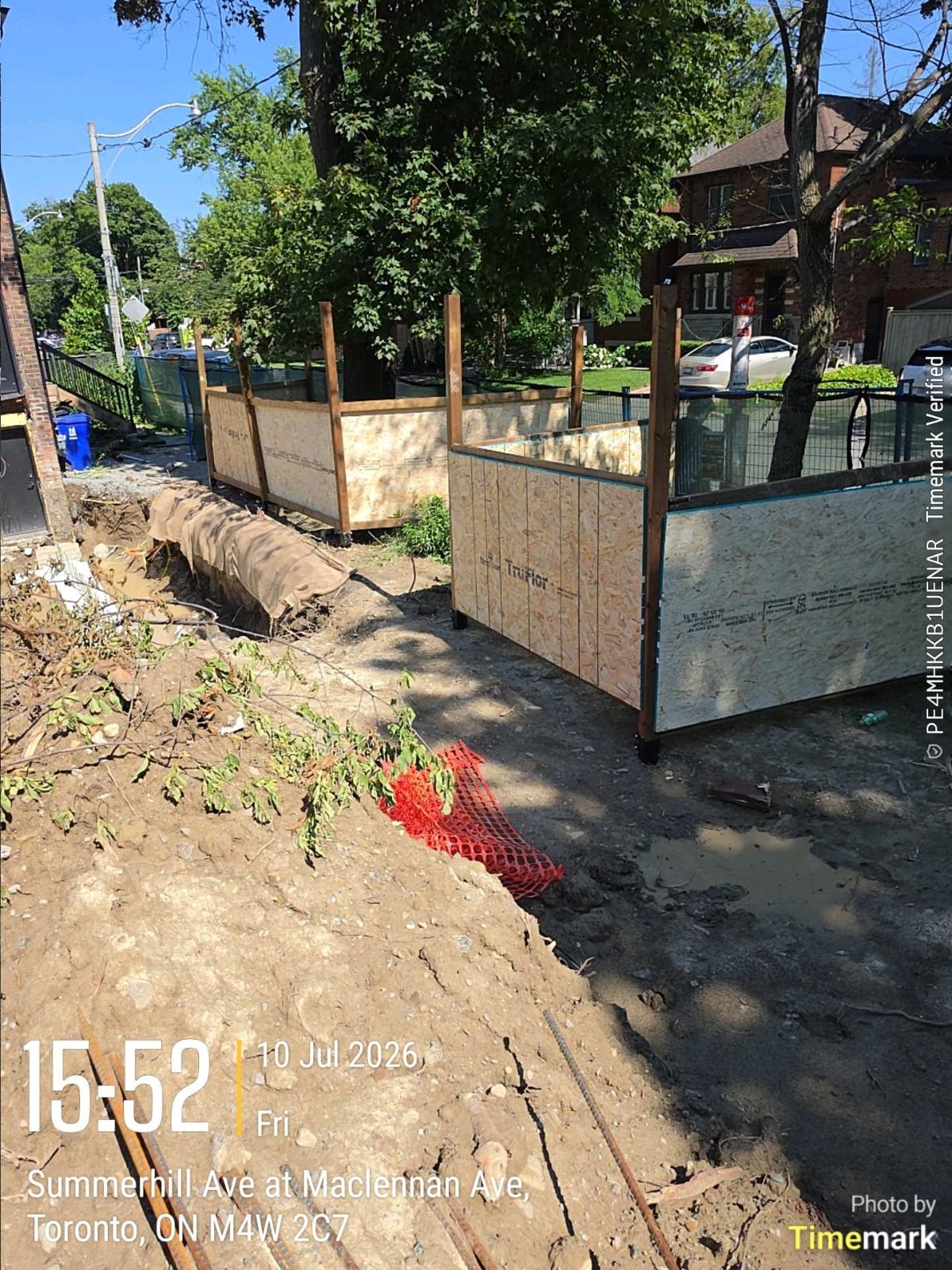 Partly backfilled site with fencing at a Toronto rear addition