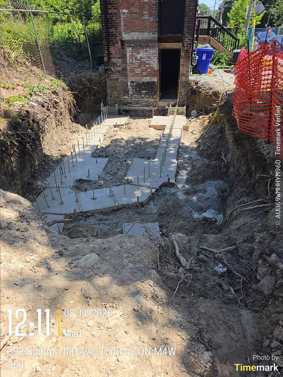 New footings in the rear yard next to the existing structure of a Toronto home