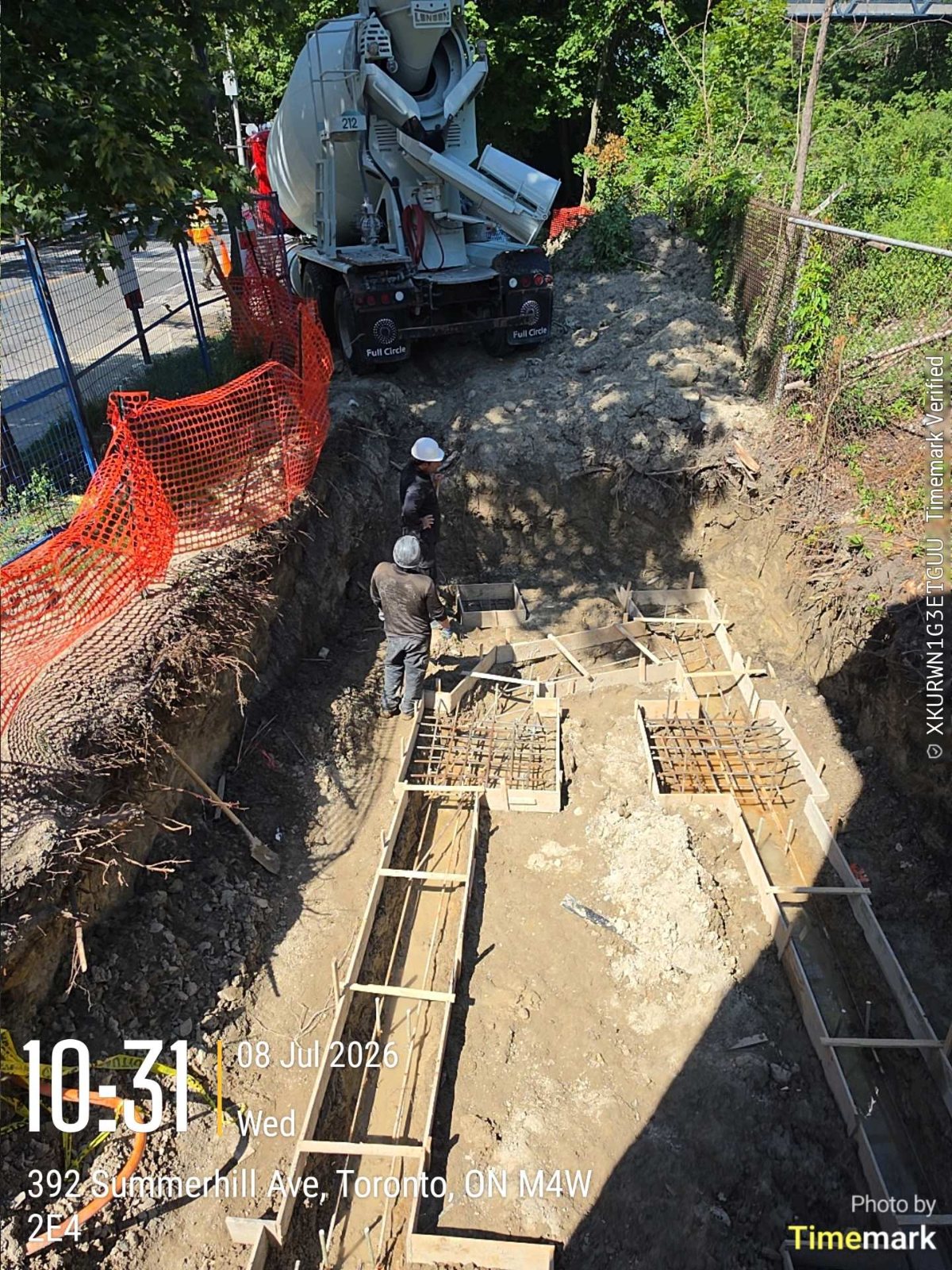 Equipment working at the footing excavation for a Toronto rear addition