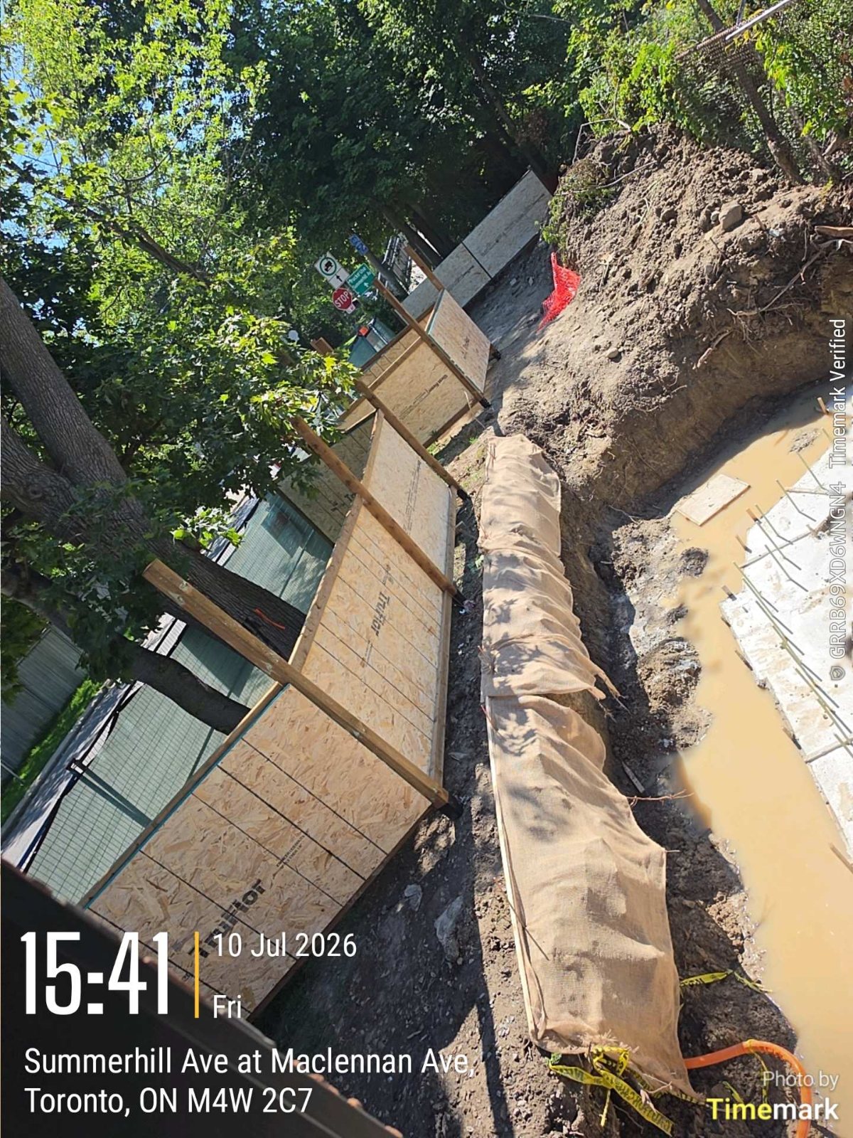 New foundation wall rising in the excavation for a Toronto rear addition