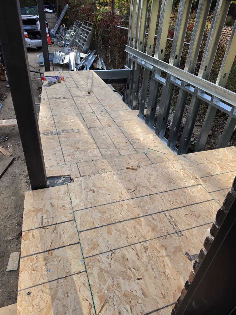 Plywood subfloor laid over new floor framing at a Toronto rear addition