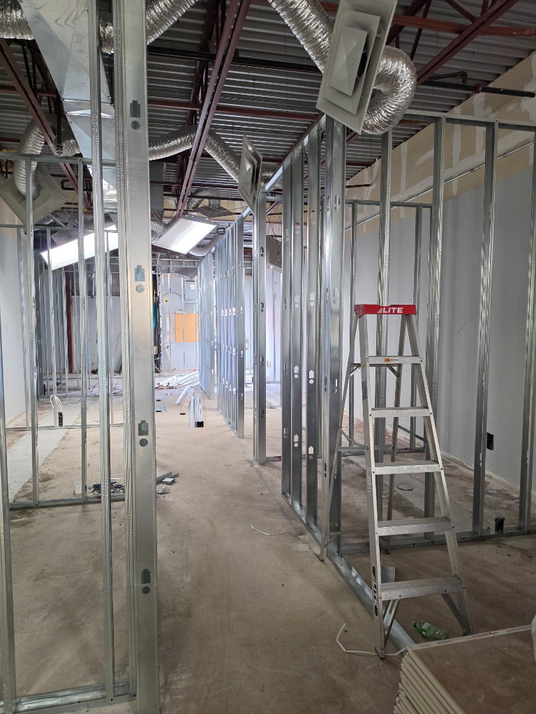 Steel stud framing and ladder for new exam rooms in a medical clinic conversion