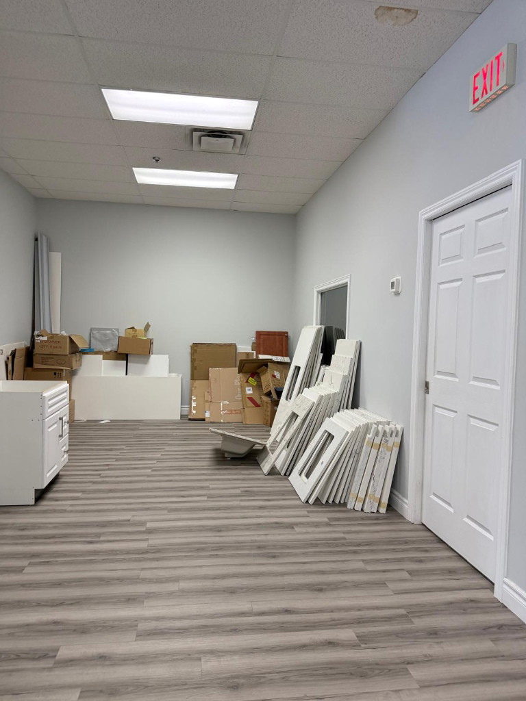Room with boxes and removed materials during the medical clinic strip-out