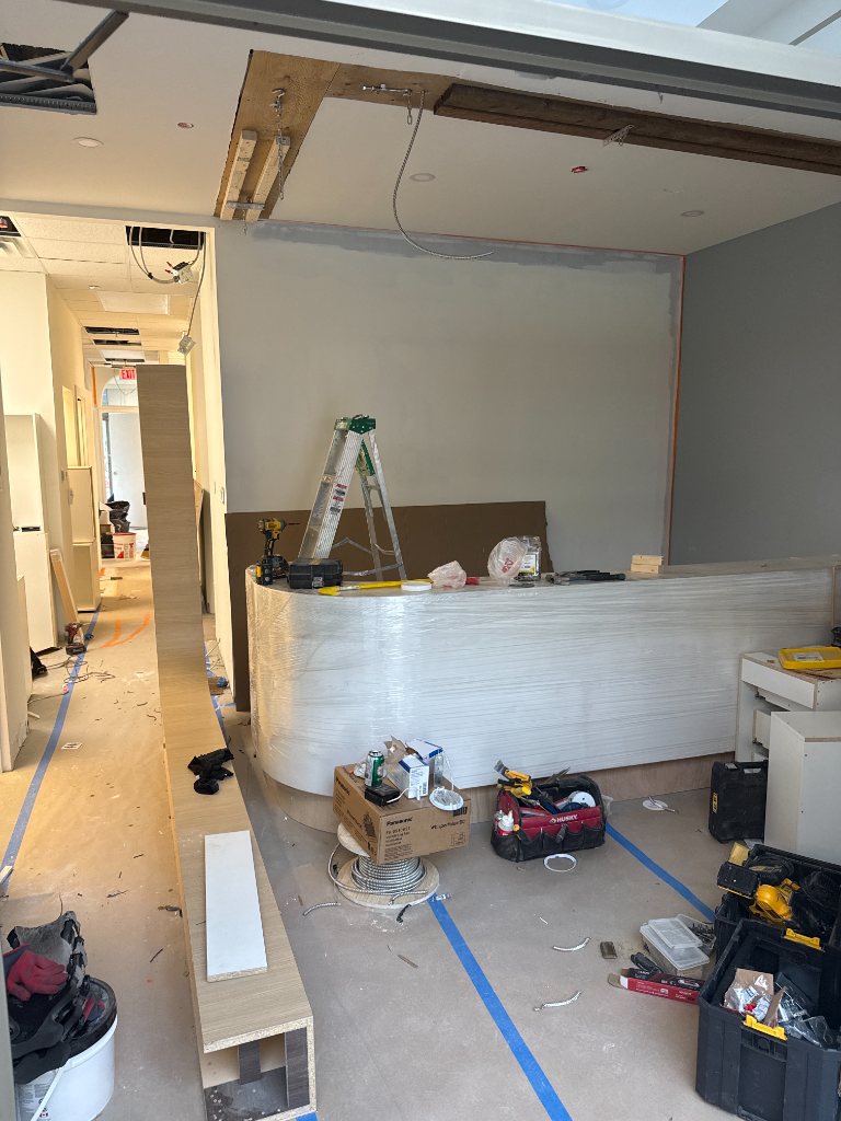 New white cabinetry being installed in a Mississauga clinic renovation