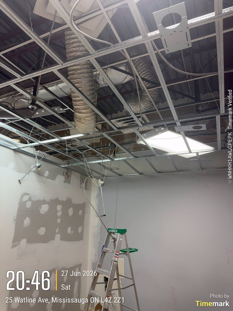 Ceiling tiles removed to expose the grid and services in a Mississauga clinic room