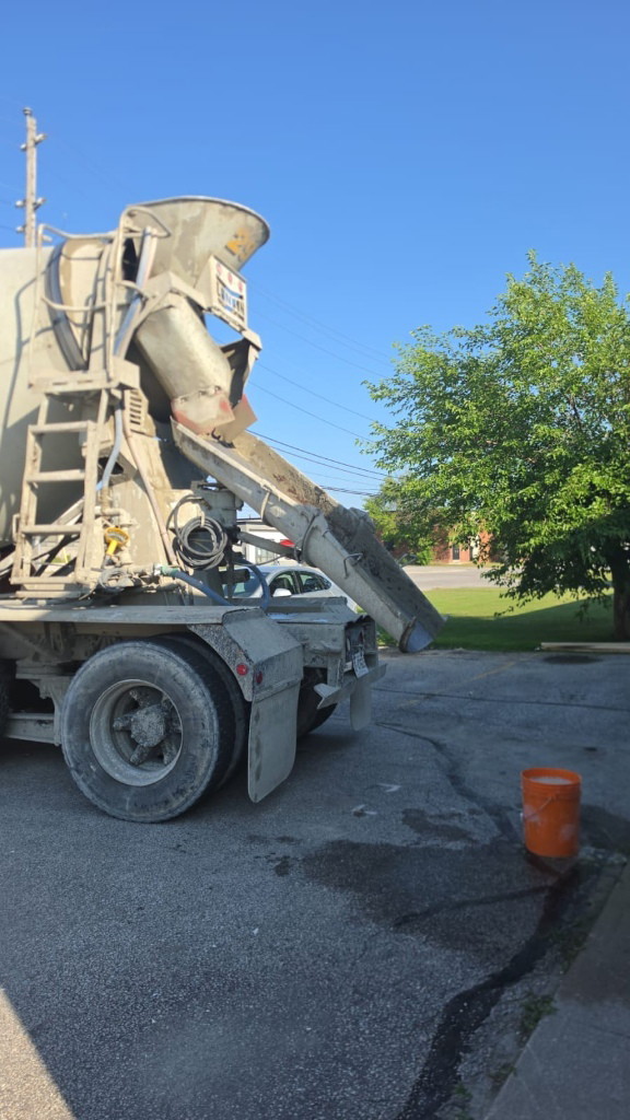 Concrete mixer truck discharging concrete on site at a Scarborough commercial facility