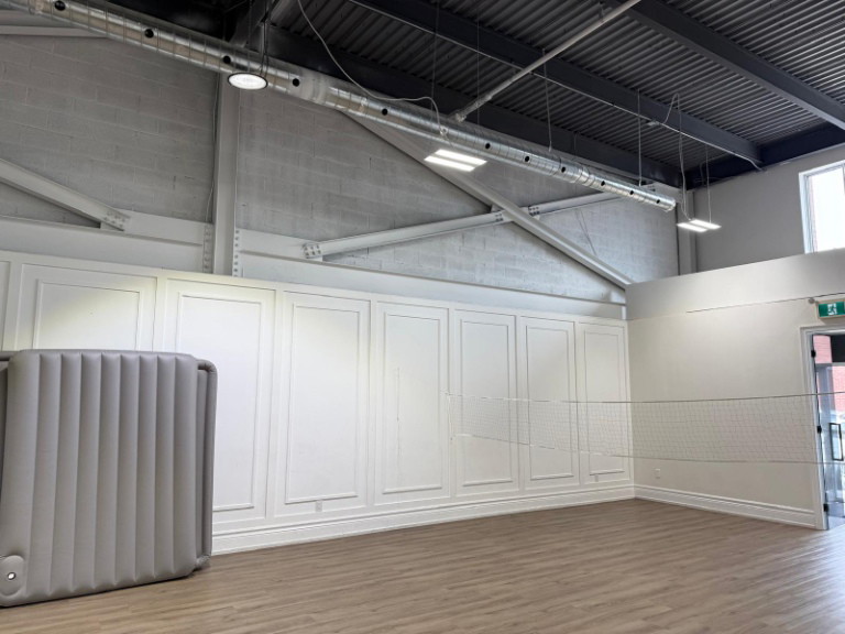Panelled feature wall and exposed ceiling structure in an Oshawa commercial unit