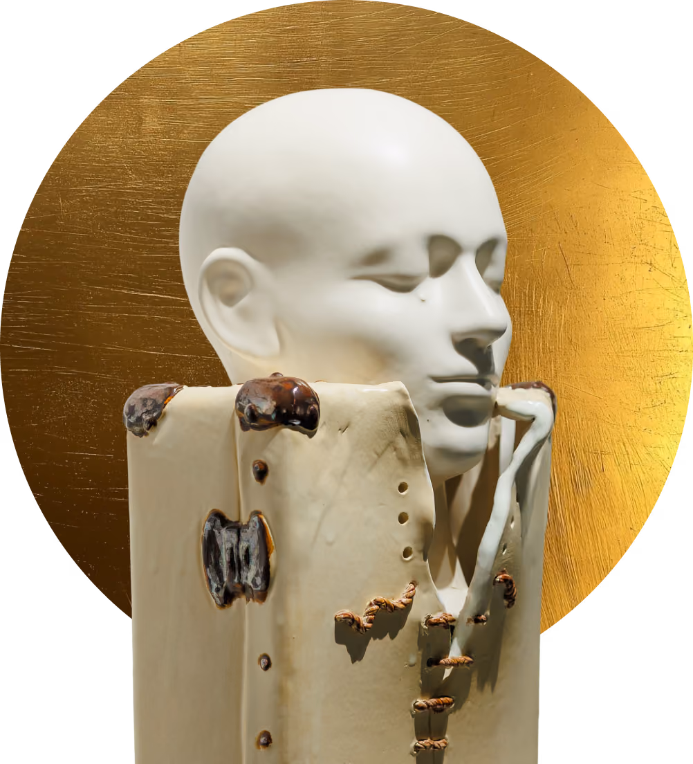 White sculpture of a serene human face on a distressed rectangular base with a golden circular background.