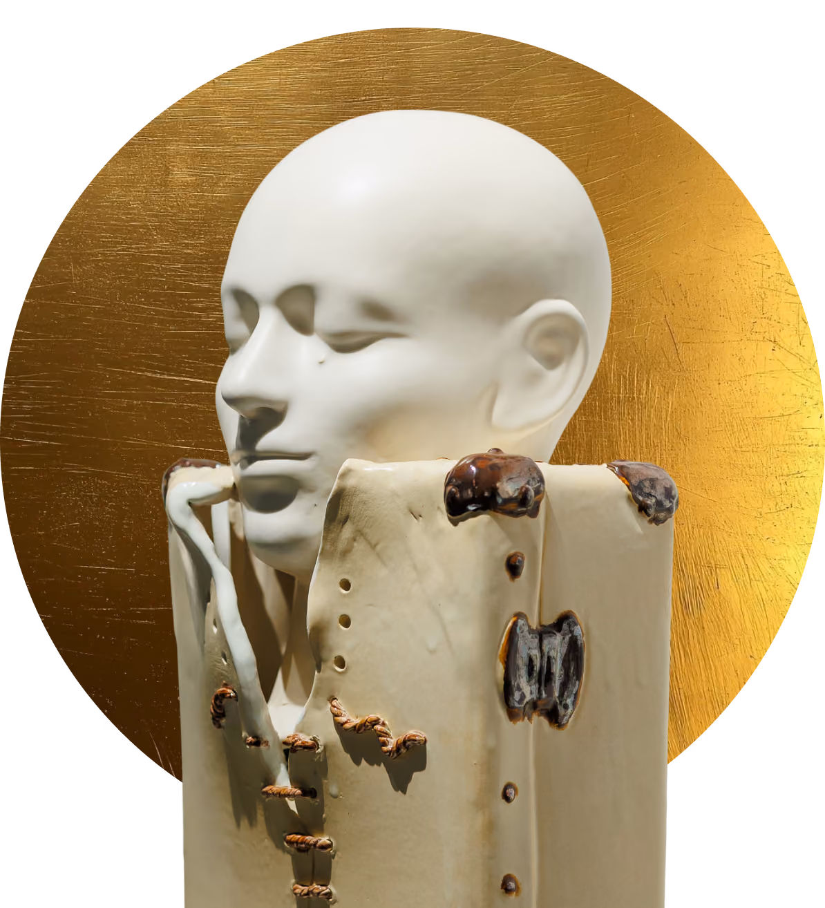 White sculpture of a serene human head emerging from a stitched, hollowed block against a gold circle.