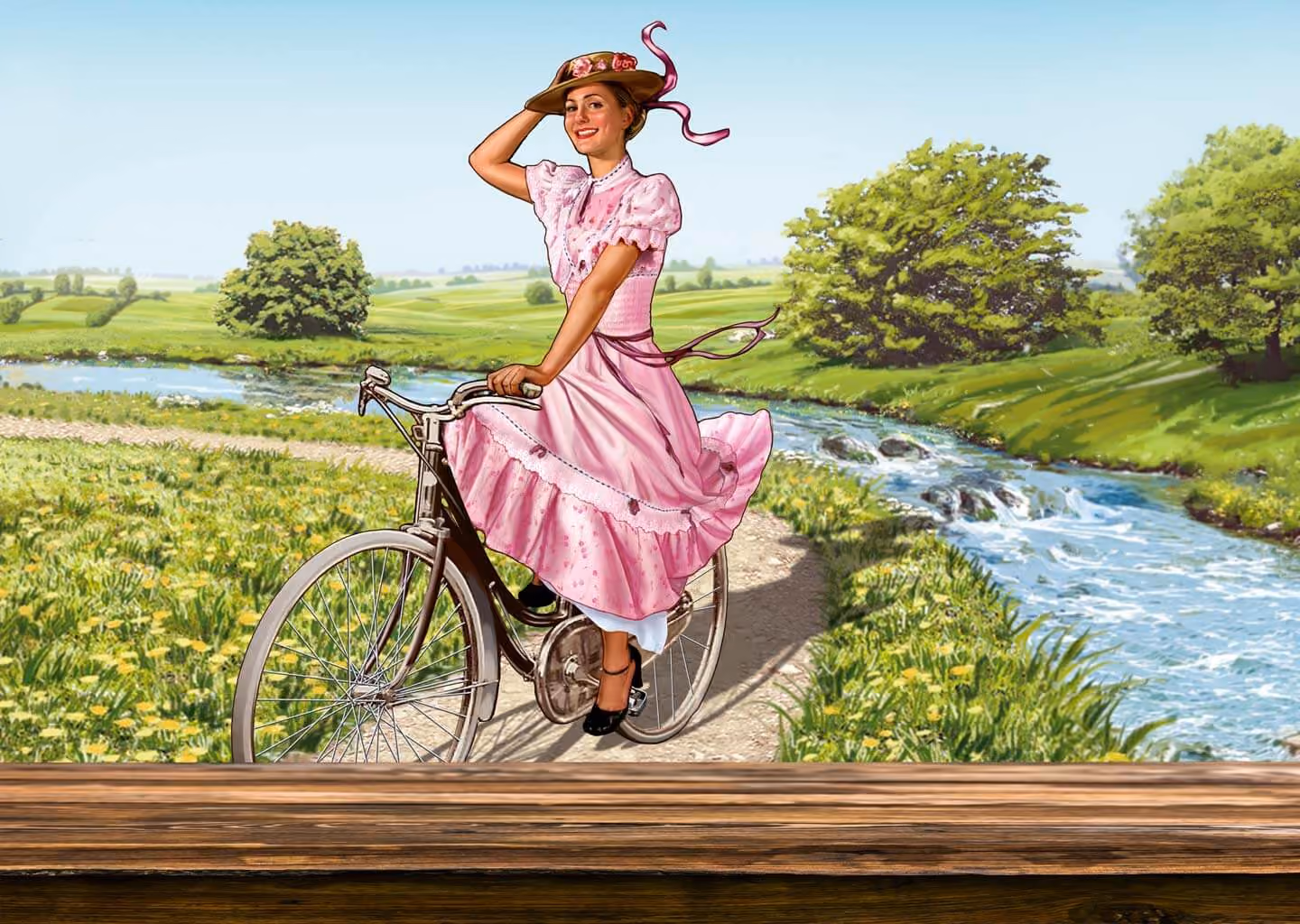 Frau in rosa Kleid und Hut fährt Fahrrad auf Weg neben Fluss und grüner Landschaft.