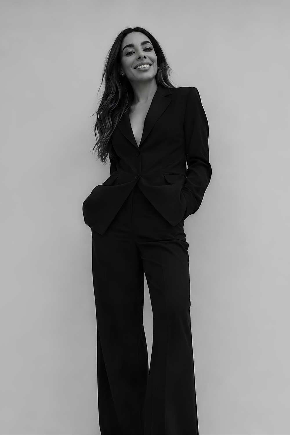 Lucy Bannister, founder of doubleseven, standing in a black suit against a plain backdrop.