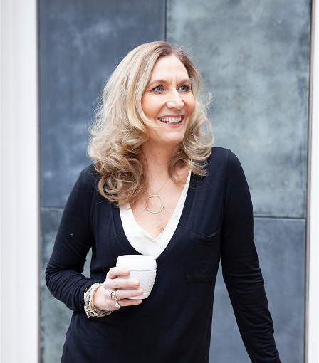Harriet Young with coffee, posing.