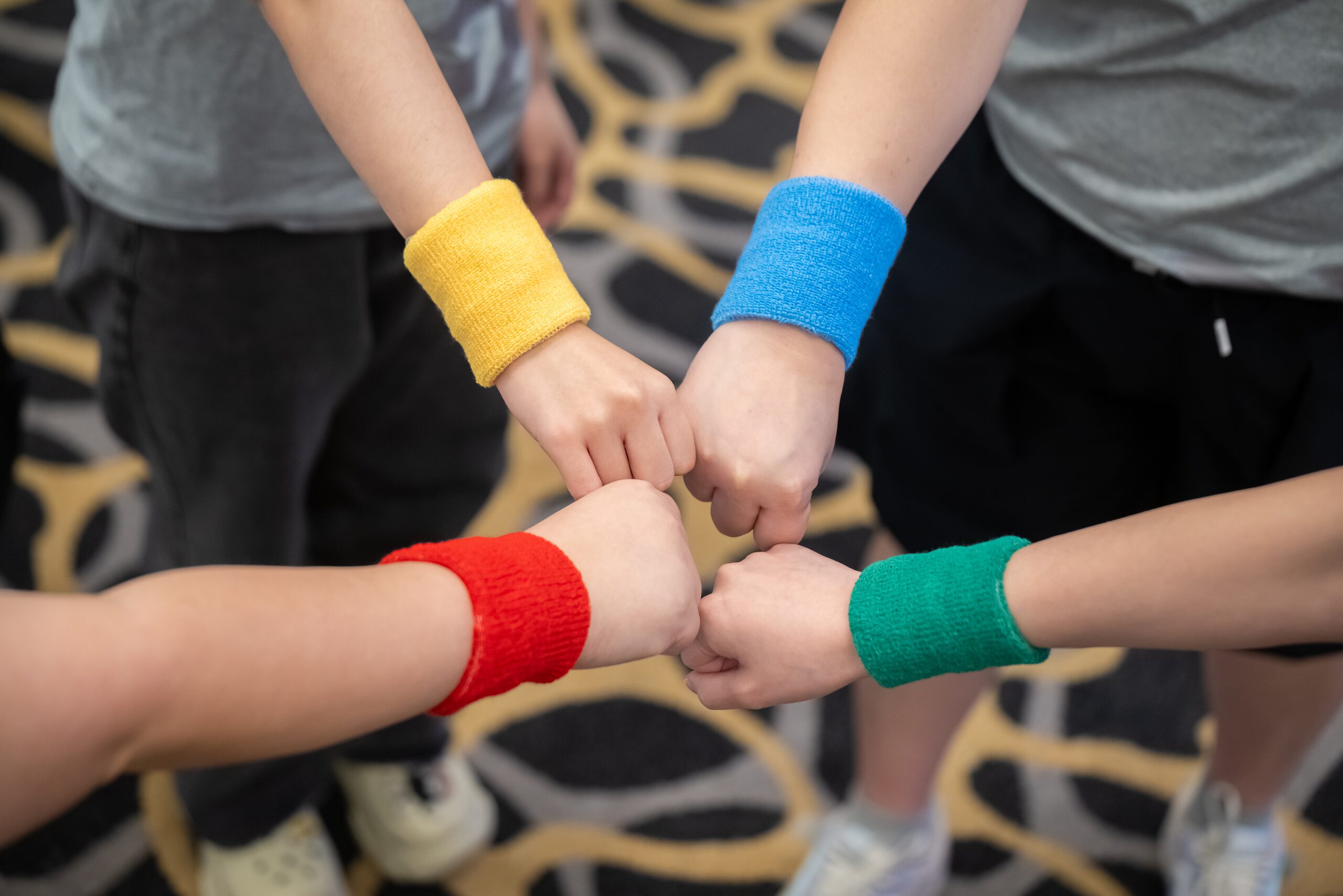 Meridian Energy colleagues joining hands during a team activity
