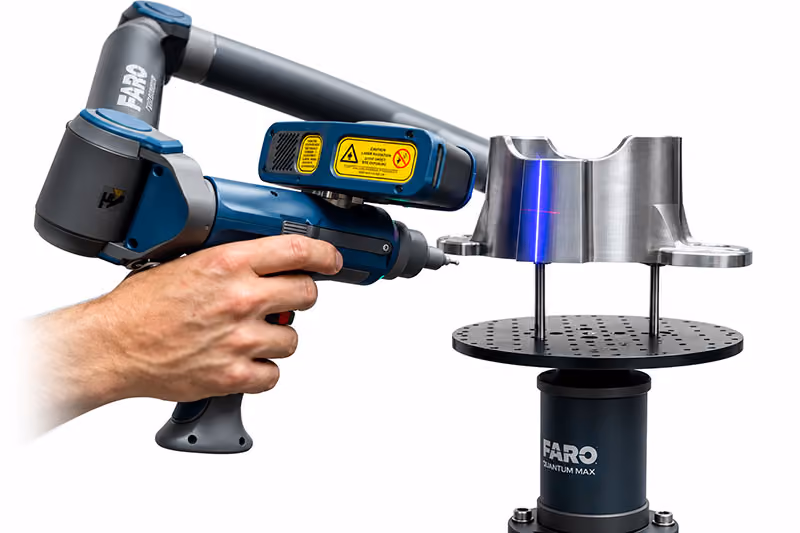 FARO laser scanning arm capturing a precision-machined metal component for reverse engineering.