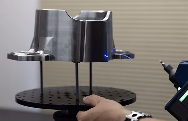 3D laser scanning of an existing machined metal part for reverse engineering and digital measurement.