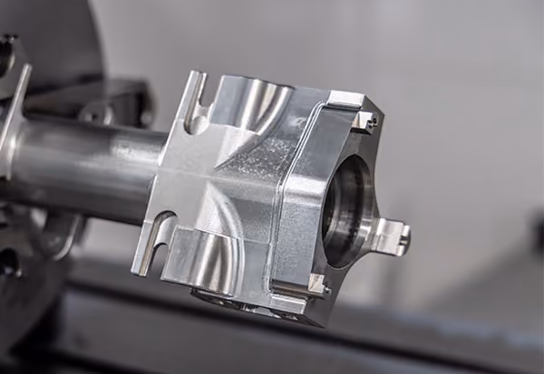 Precision-machined metal component showing complex geometry and finished surfaces after CNC machining.