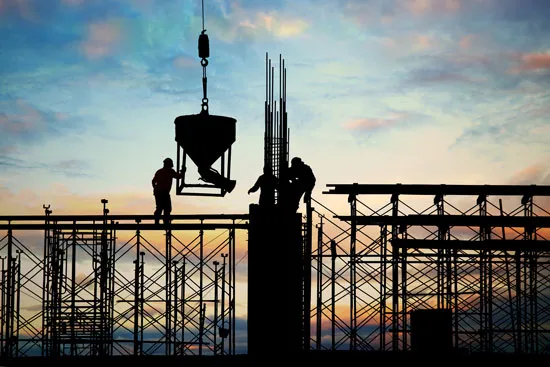 Silhouette of a construction worker at a job site