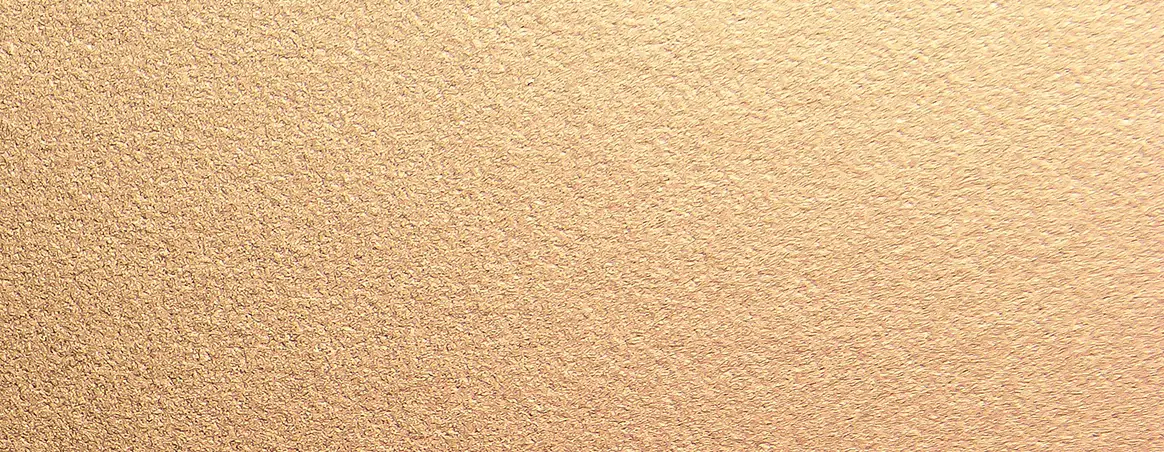 Textured shimmering gold surface with a metallic finish.