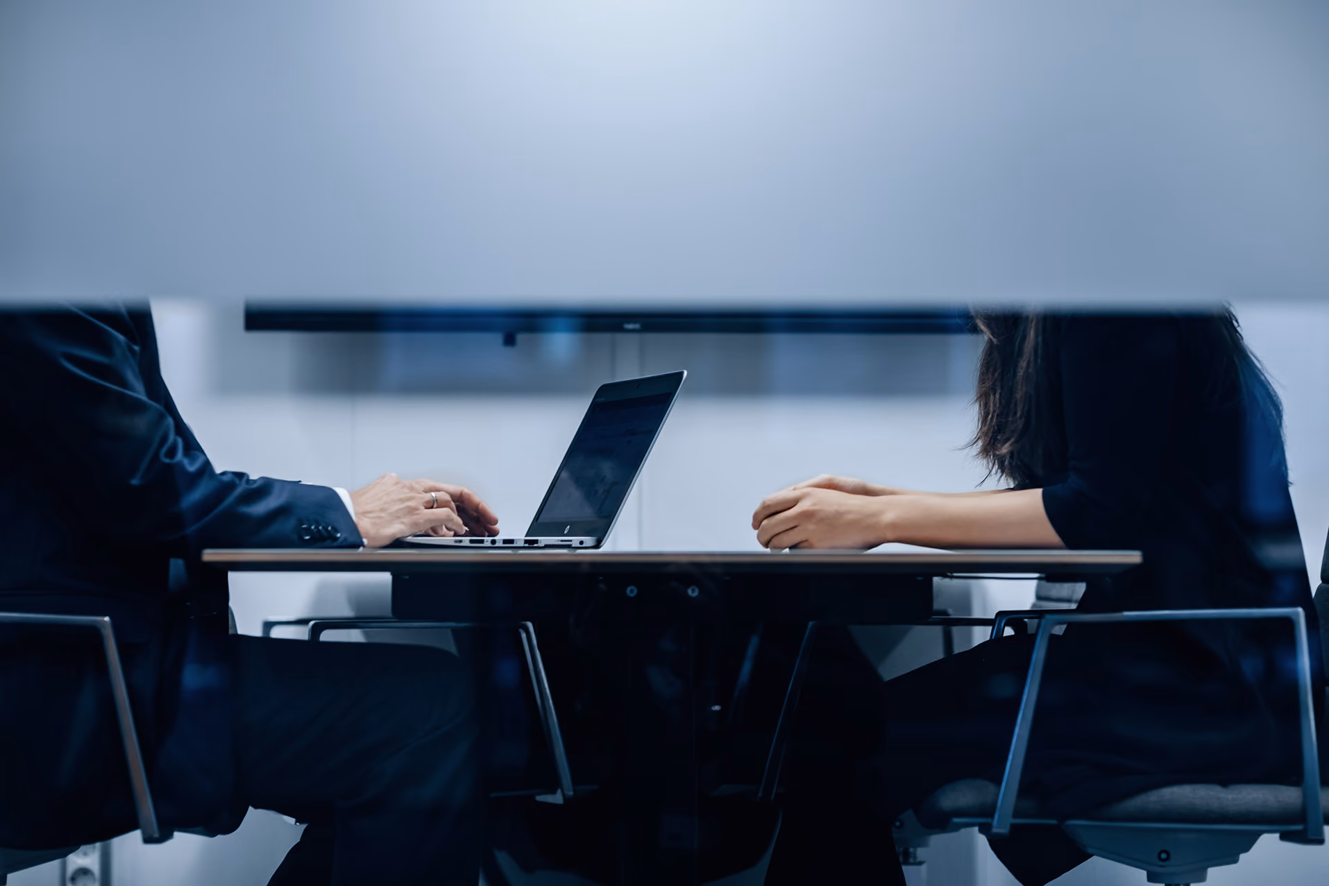 Business colleagues in a meeting reviewing a laptop together