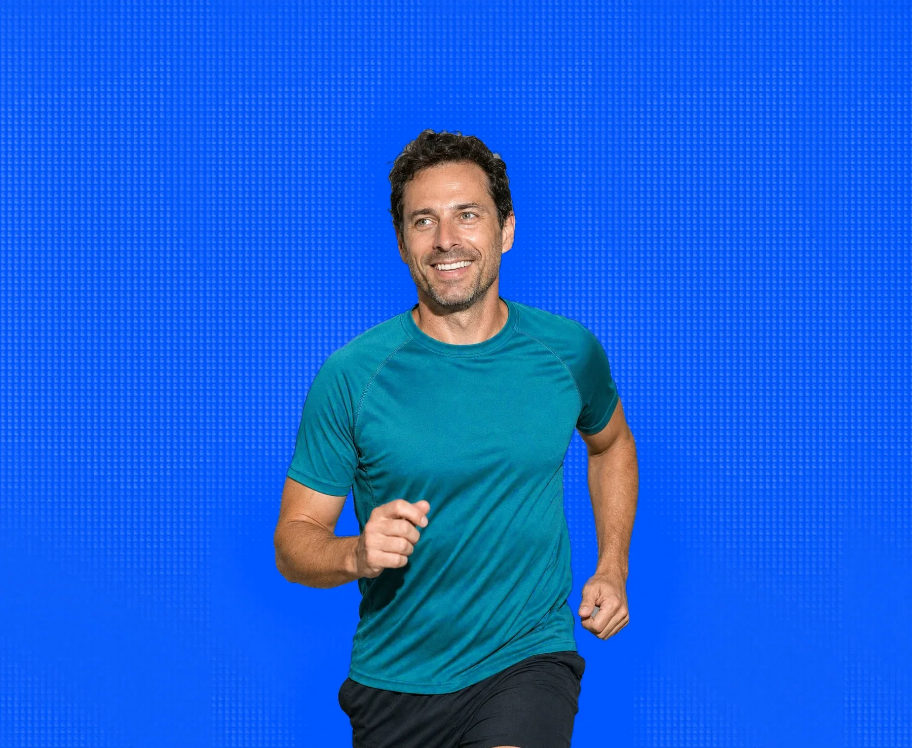 A man in his forties out running, mid stride