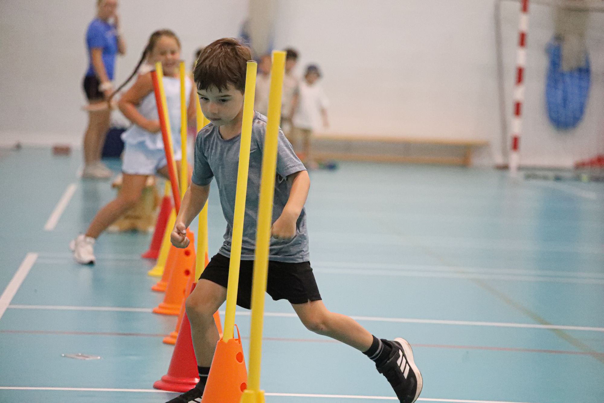 A child taking part in an indoor agility activity