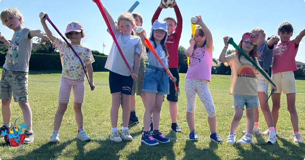 Children at a Sports Bug holiday club holding up foam javelins