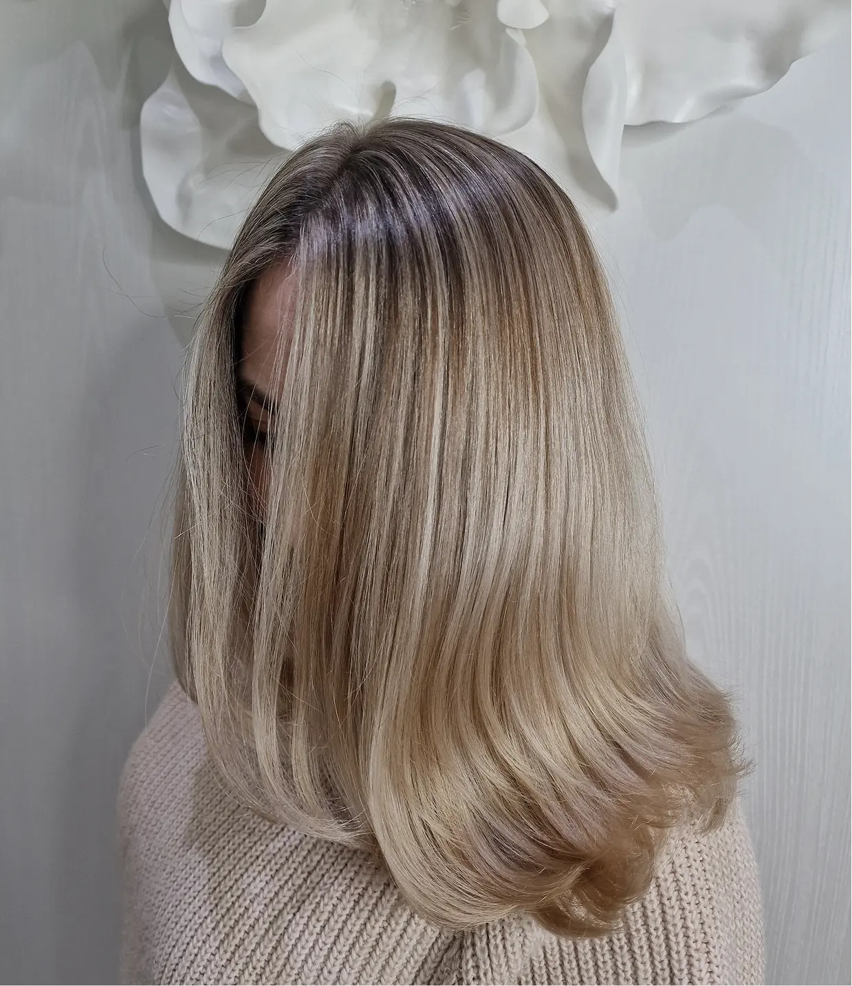 Back view of long light brown hair styled in soft waves.
