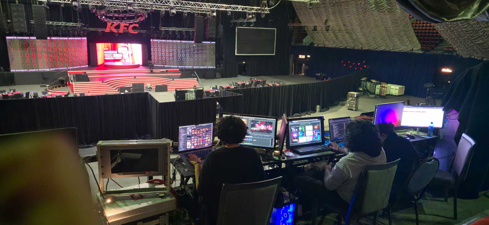Production crew working at computers at an event