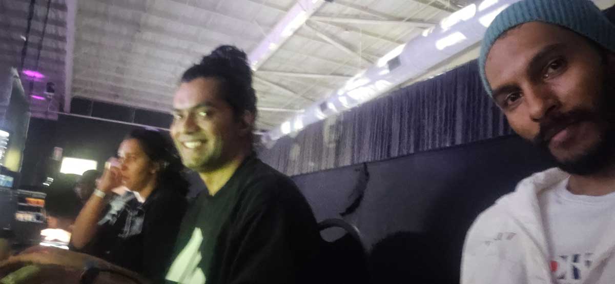 Three colleagues behind the scenes at a live event