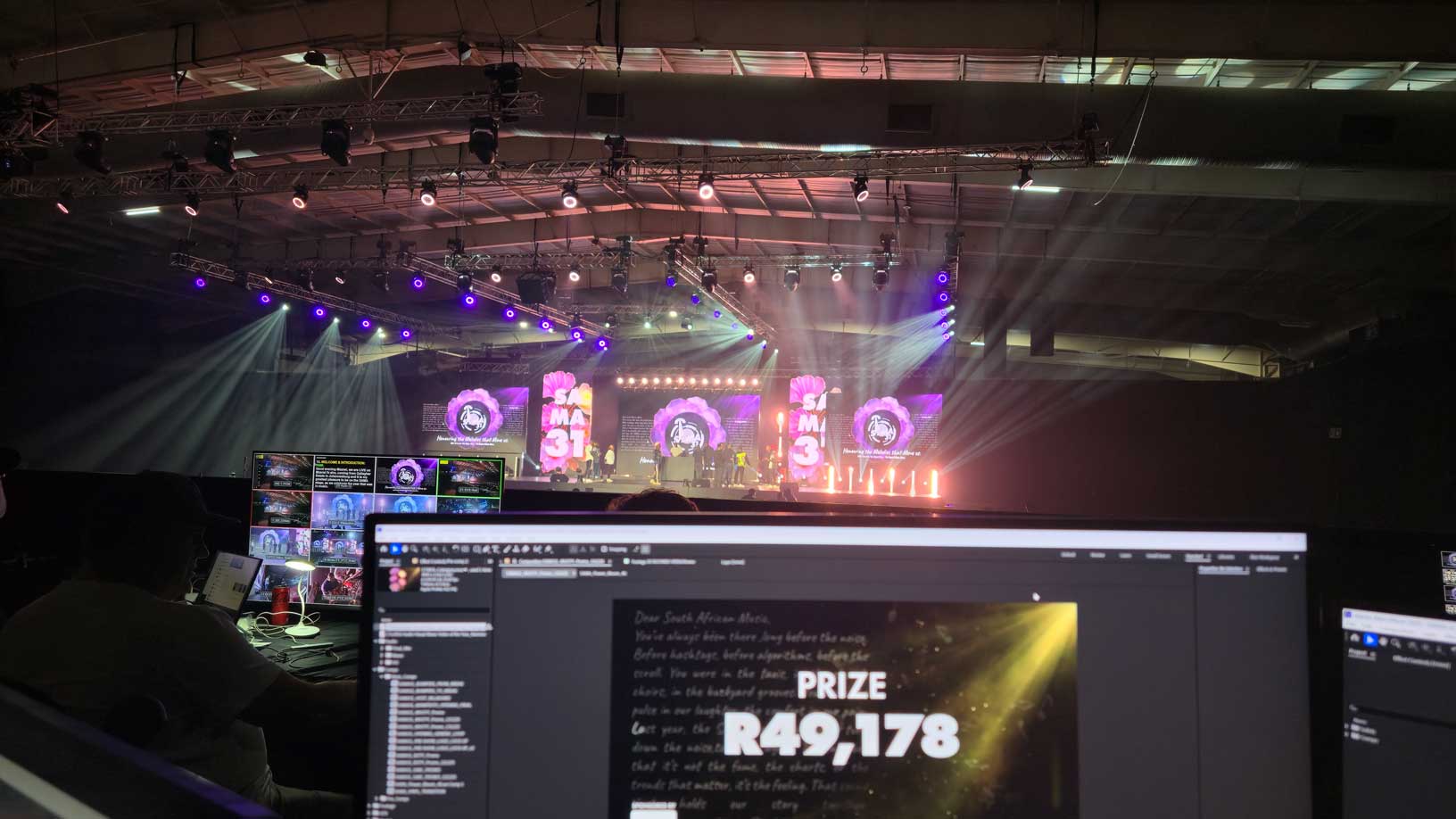 Editing workstation in front of an illuminated event stage