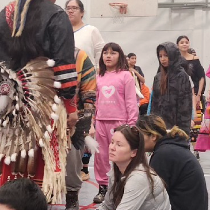 A cultural gathering with traditional regalia