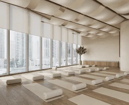 a large room with yoga mats and windows