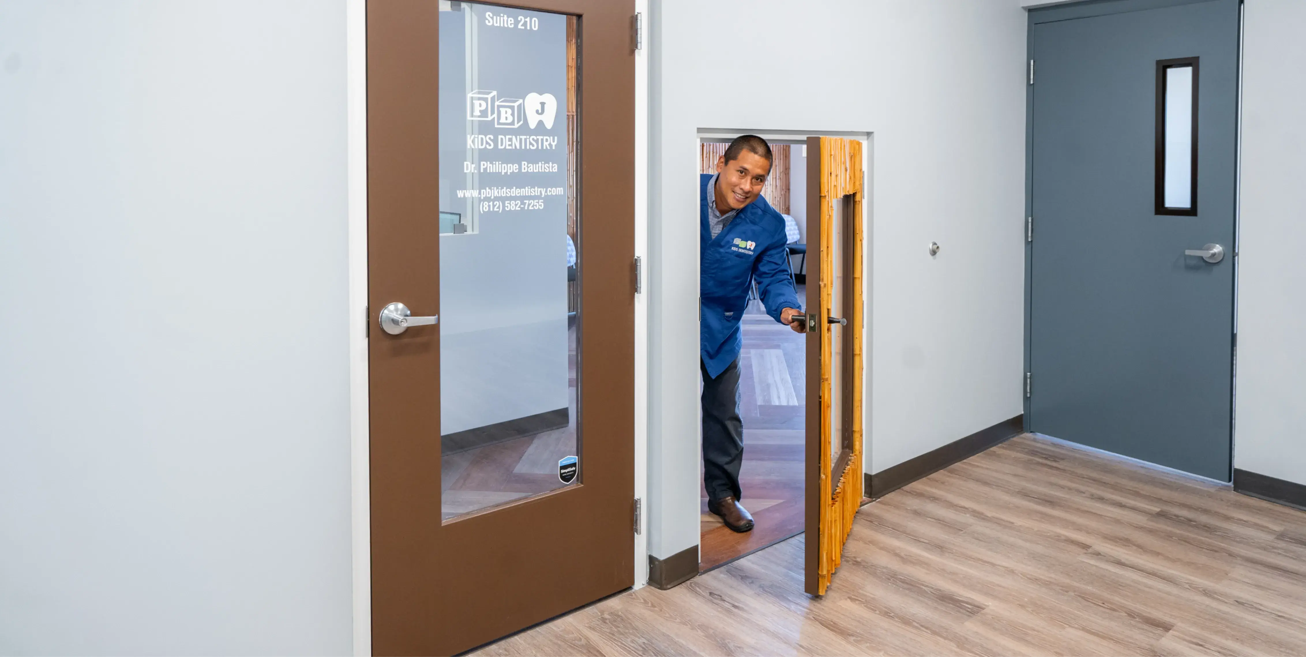 A man opening a door to a room.