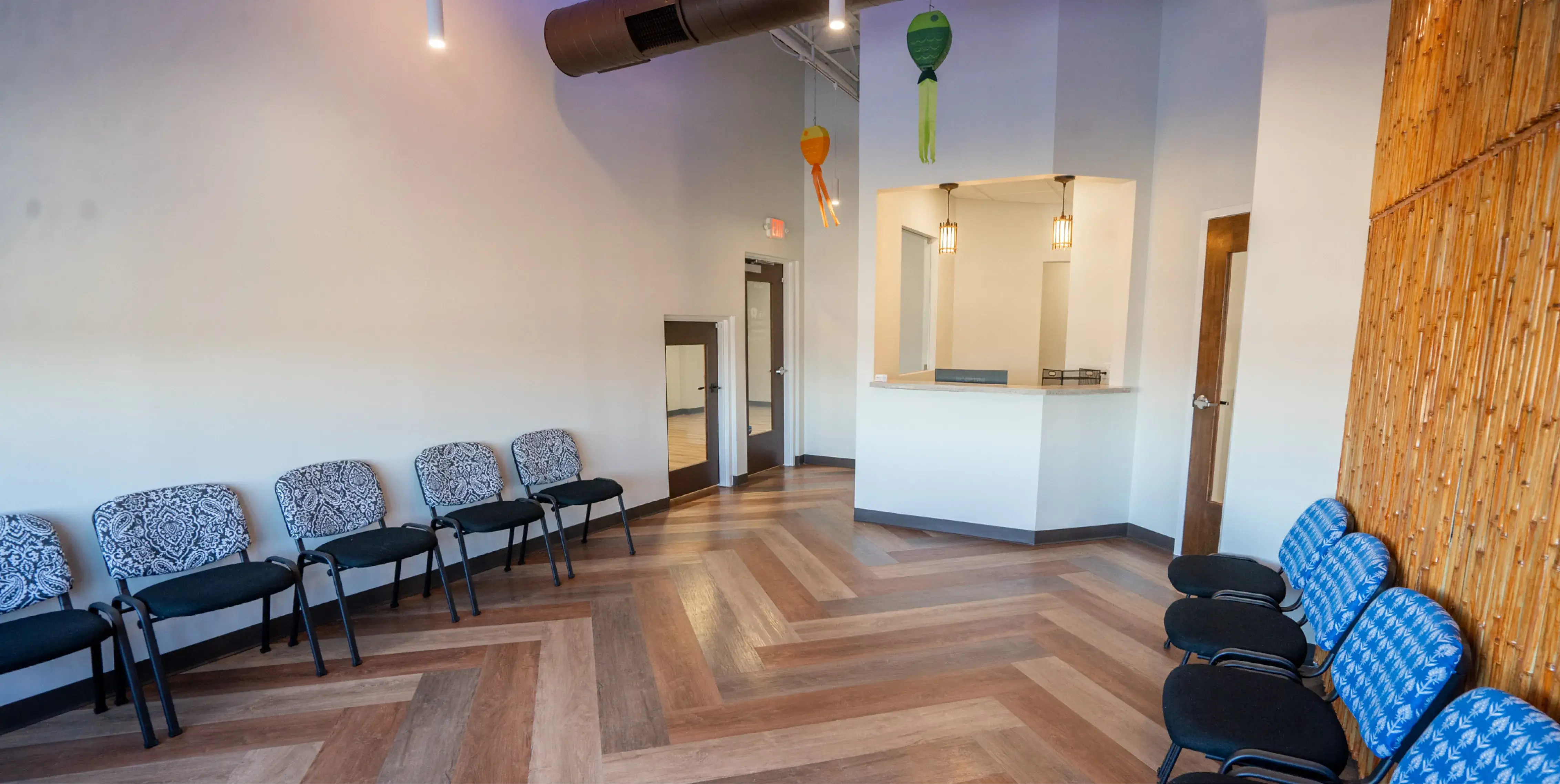 A row of chairs sitting in a room next to a wall.