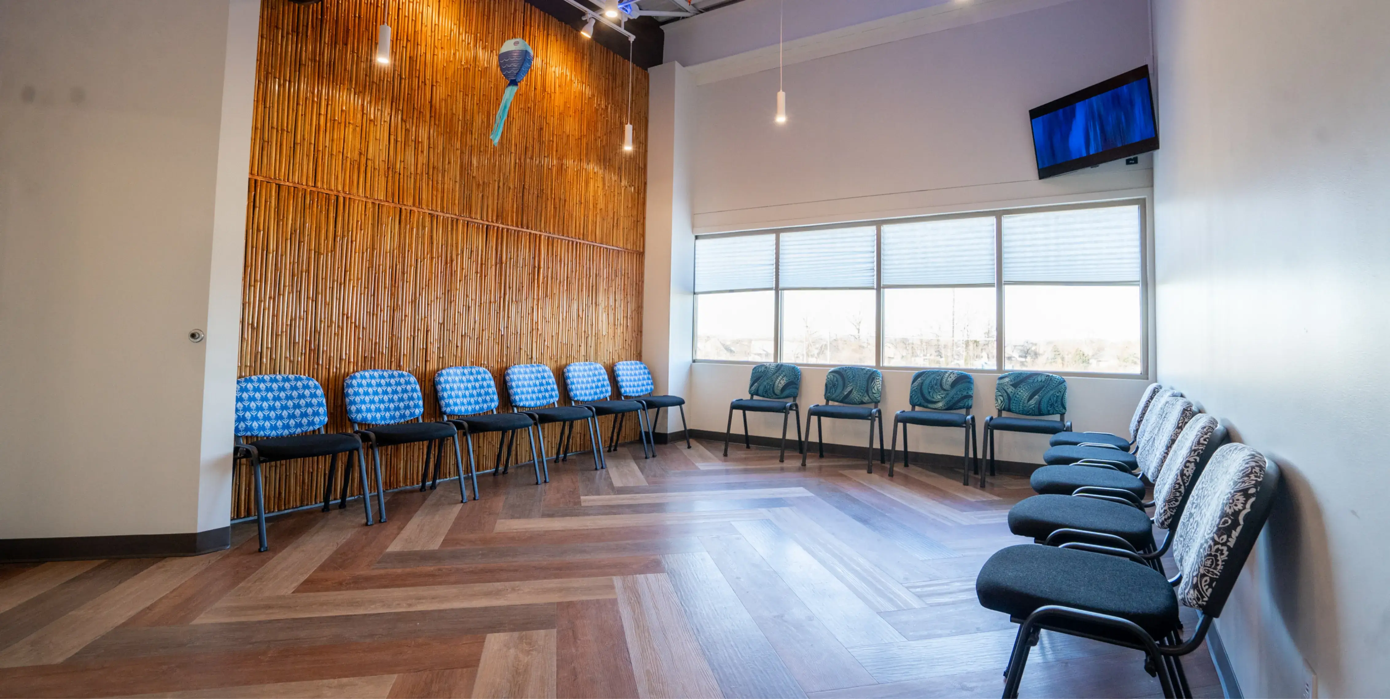 A row of blue chairs sitting in a room.