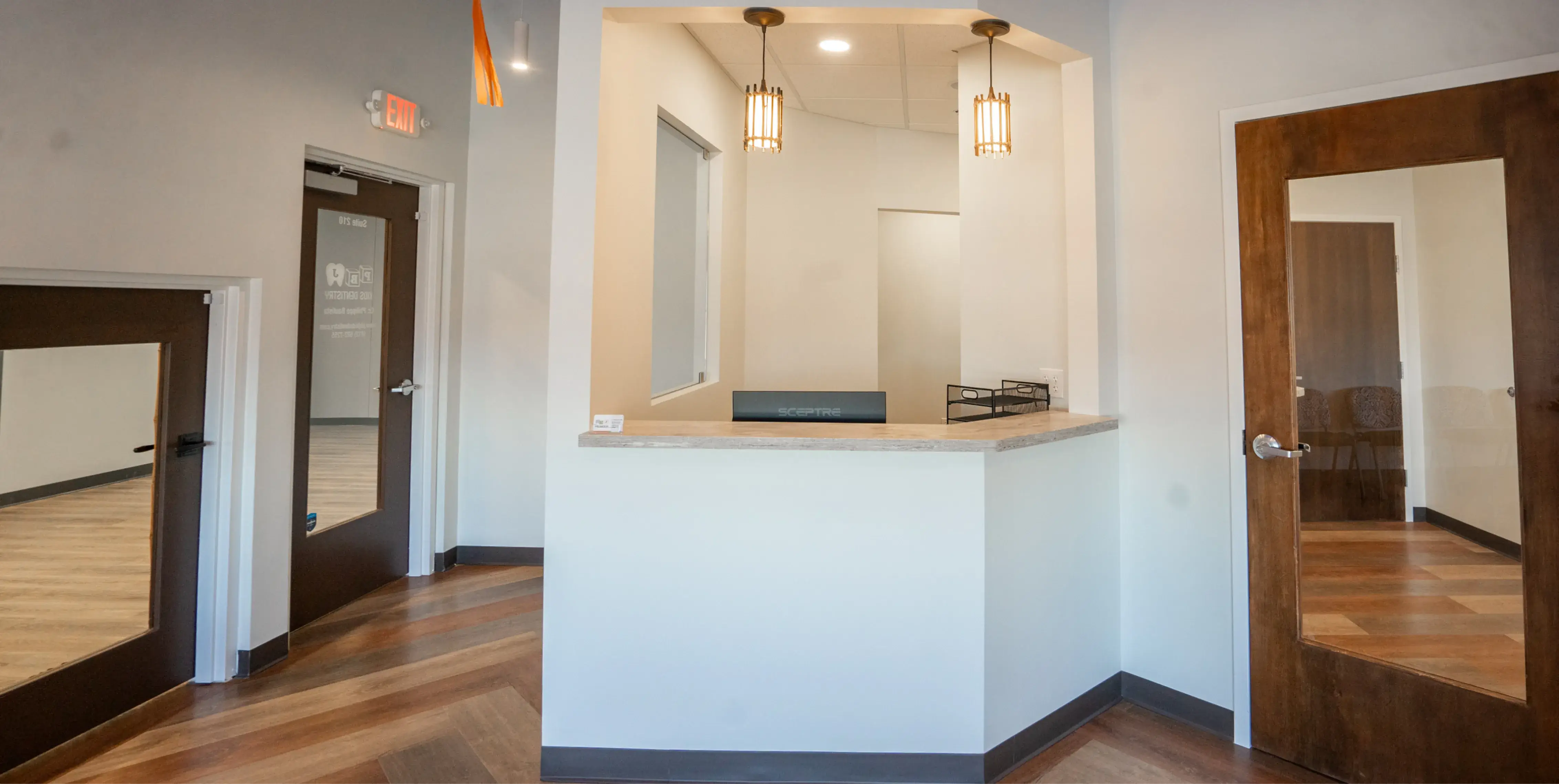 An empty room with a counter and two doors.