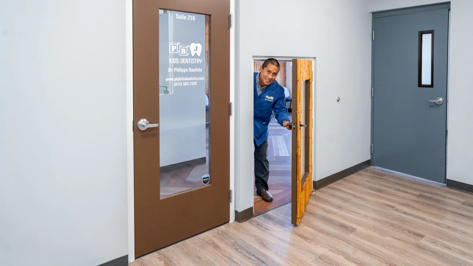 A man opening a door to a room.