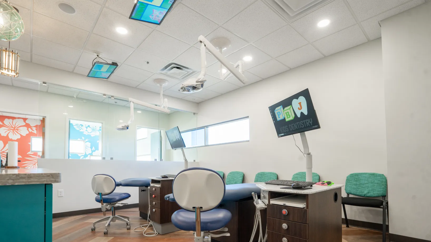 A dental office with chairs and a desk.