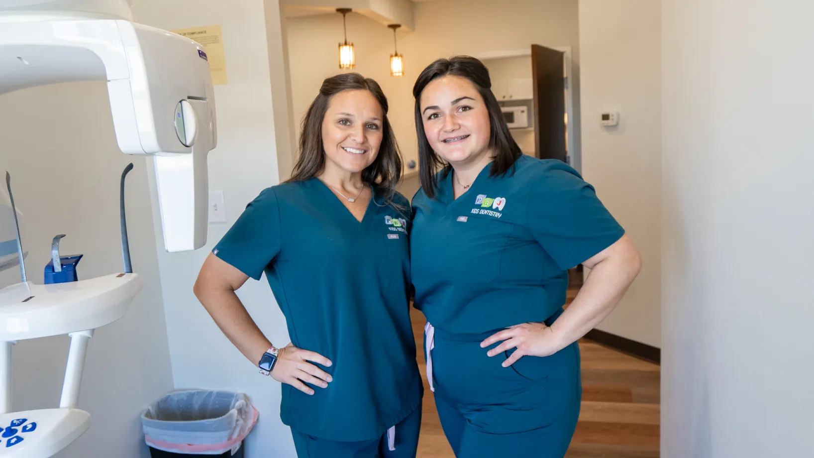 A couple of women standing next to each other in a room.