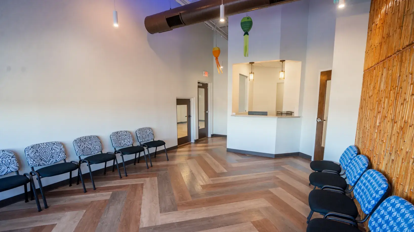 A row of chairs sitting in a room next to a wall.