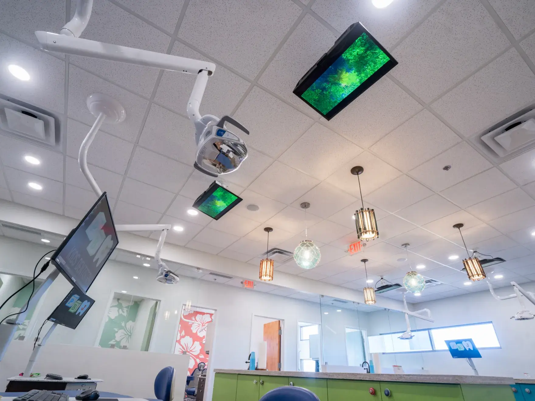 A room that has a bunch of lights hanging from the ceiling.