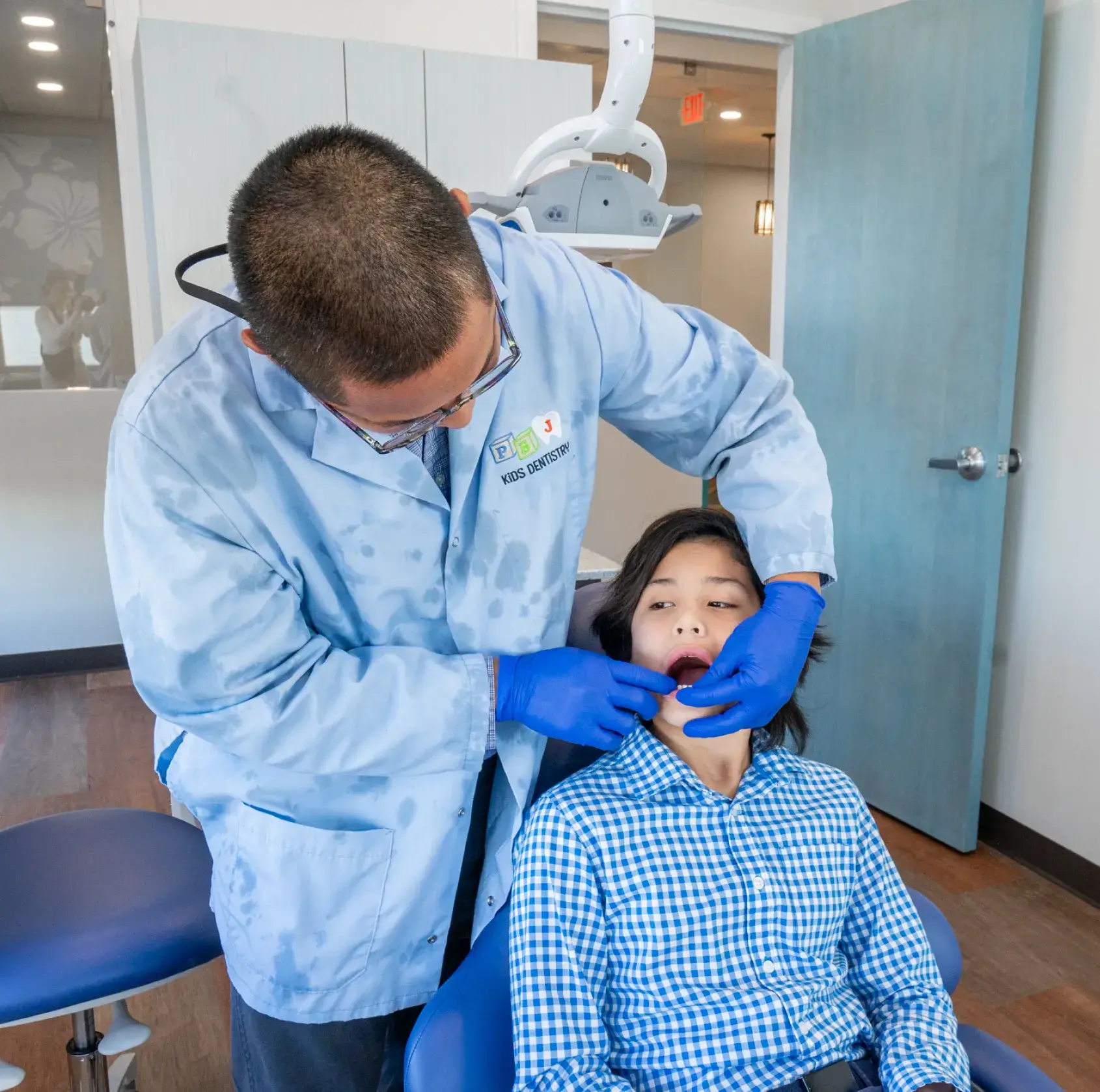 A man getting his teeth checked by a dentist.