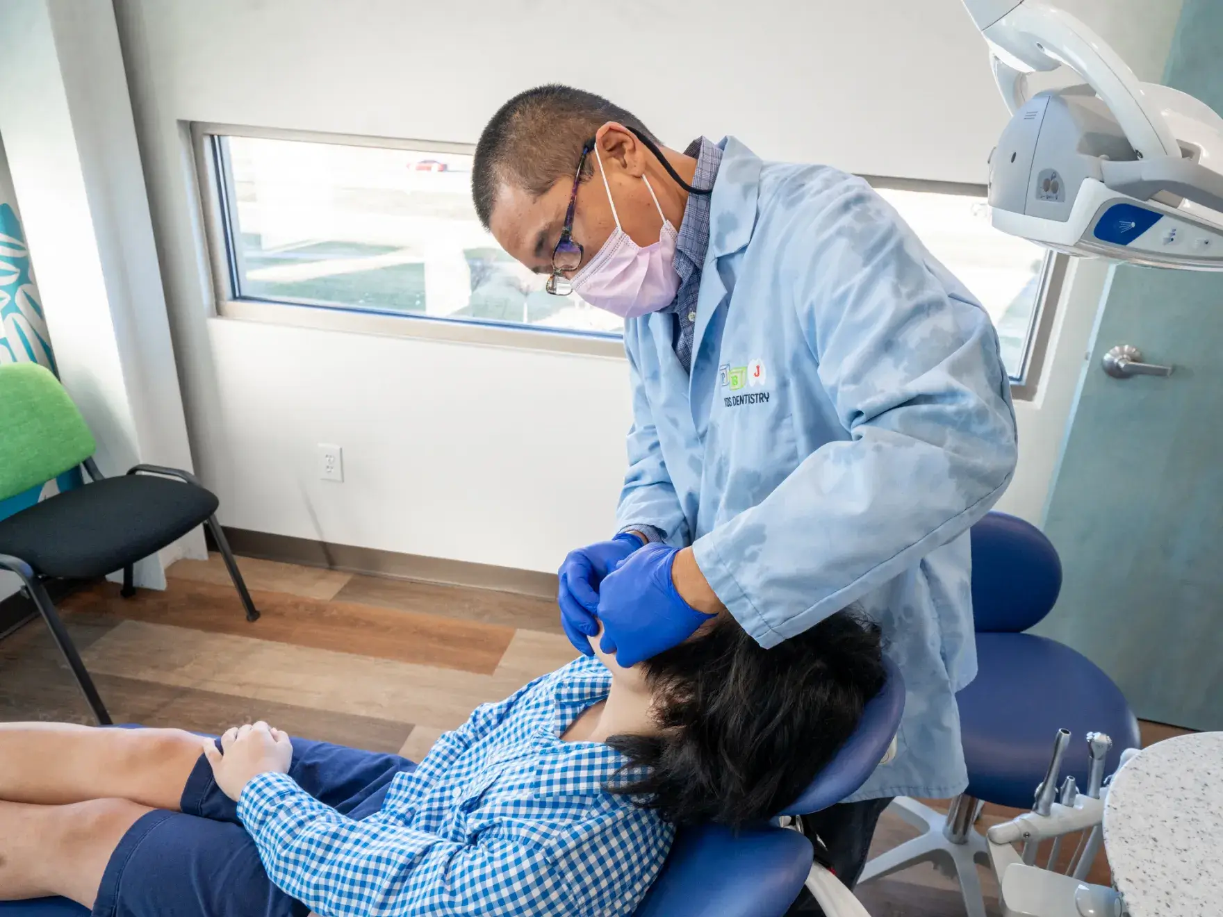 A man getting his teeth checked by a dentist.
