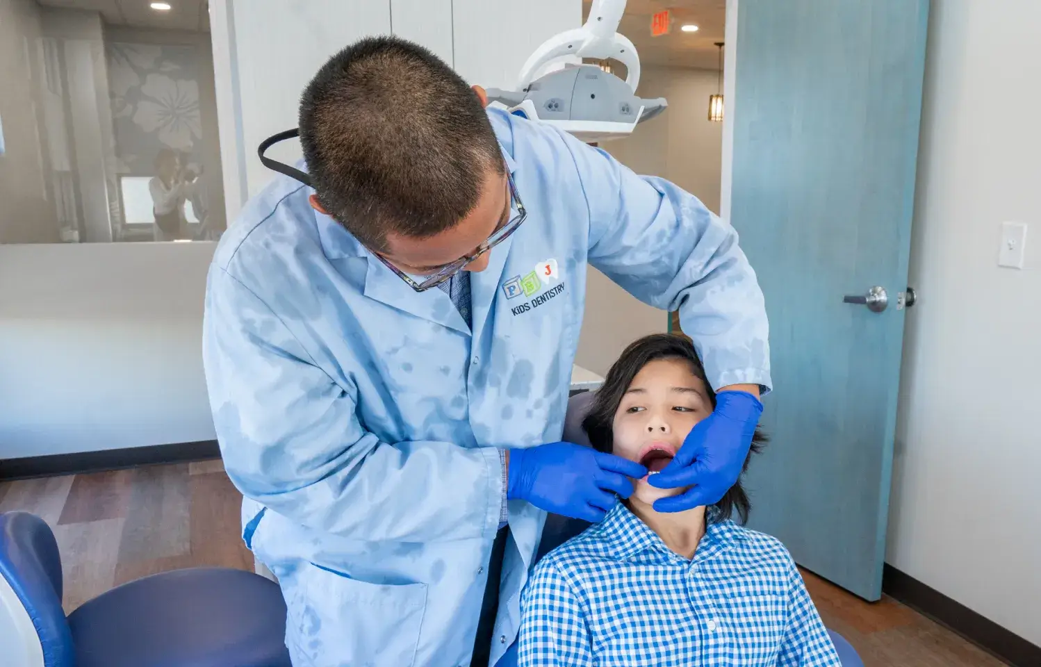 A woman getting her teeth checked by a dentist.